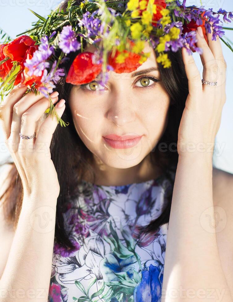Portrait of young pretty girl with flower wreath photo