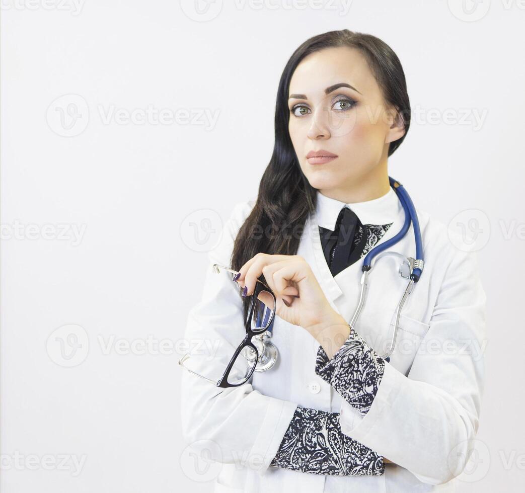 Young beautiful woman doctor on white background photo