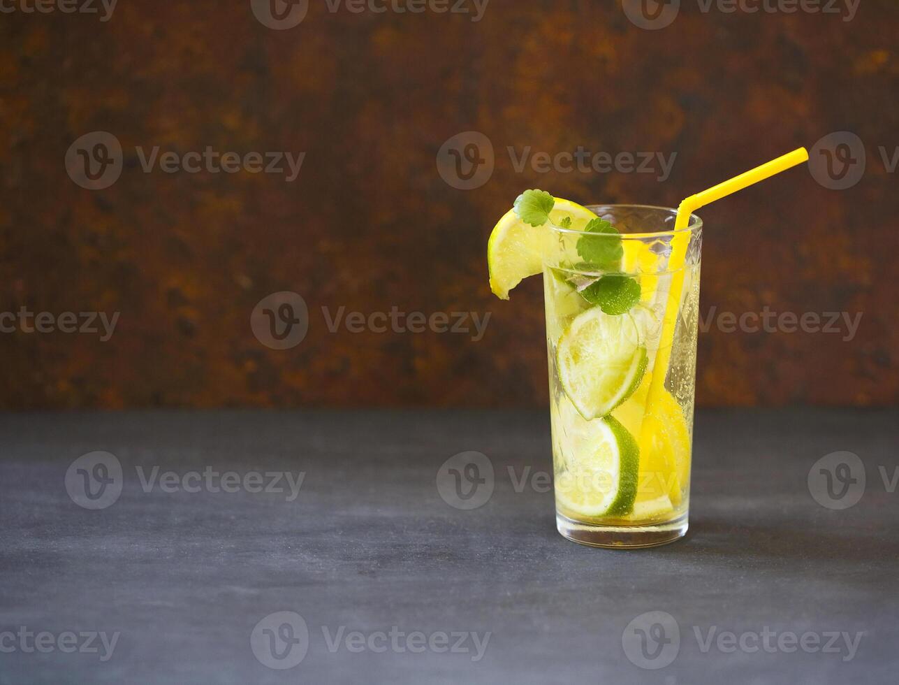 Close up of mojito cocktail in the glass on dark background photo
