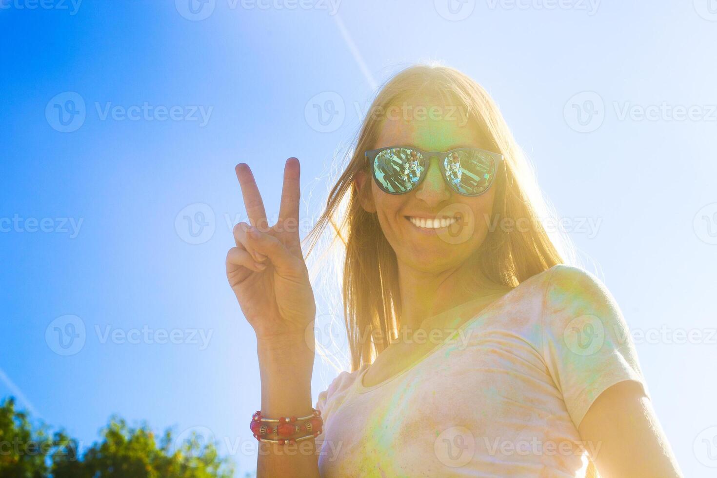 Happy young woman on holi color festival photo