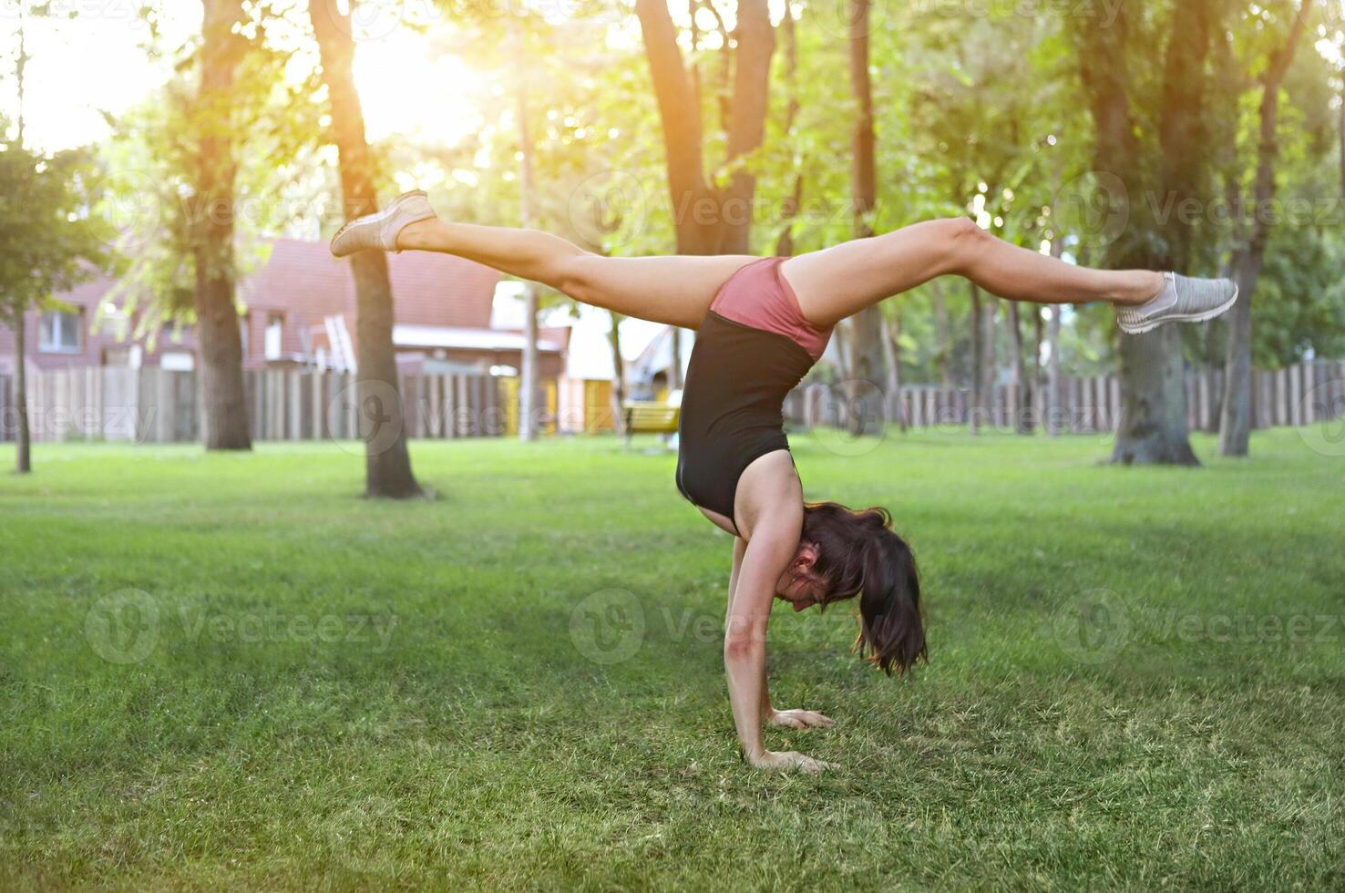 Stretching woman in outdoor exercise smiling happy doing stretches photo