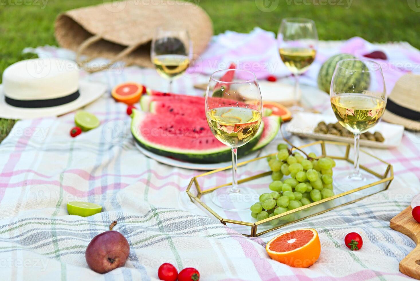 Picnic with white wine on green grass photo