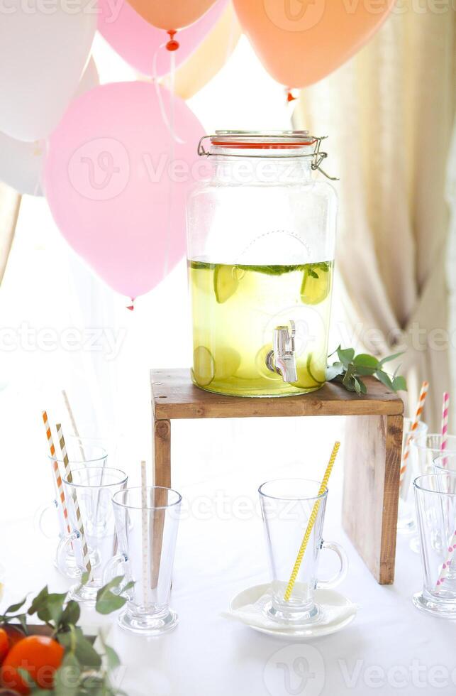 Citrus homemade lemonade in a beverage dispencer photo