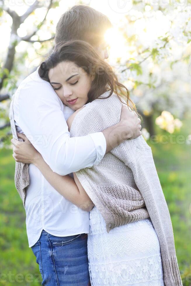 Couple in love kissing and hugging in spring park photo
