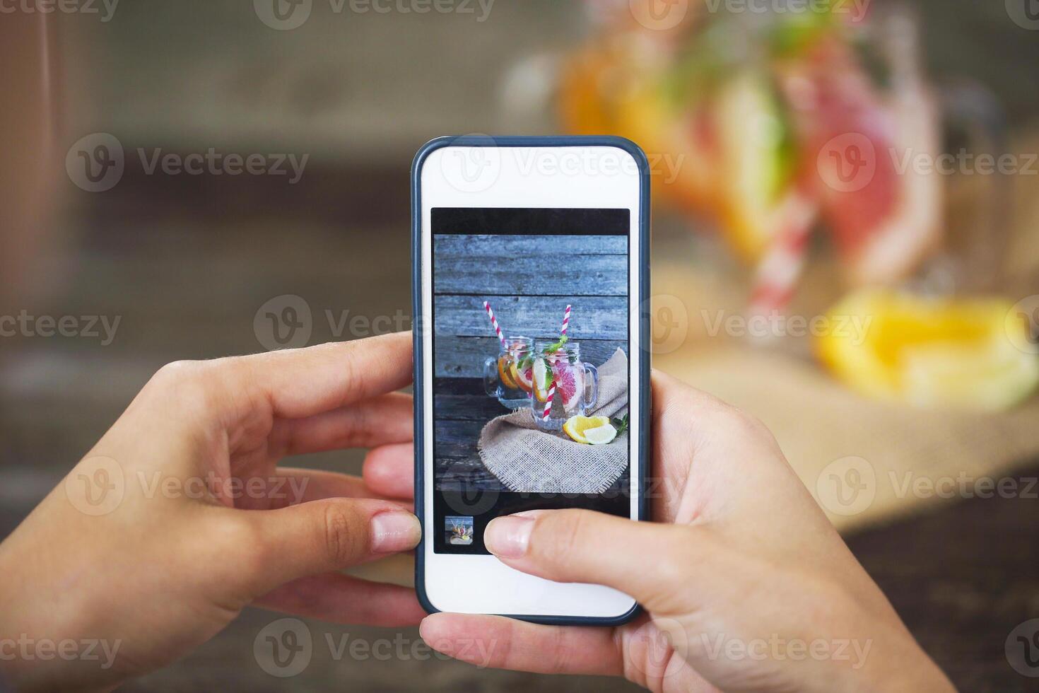 Taking photo of freshly squeezed lemon juice in glasses