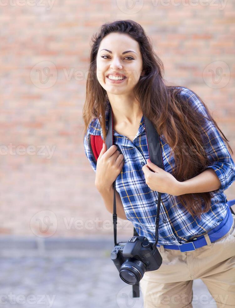 Outdoor summer smiling lifestyle portrait of pretty young woman having fun in the city in Europe photo