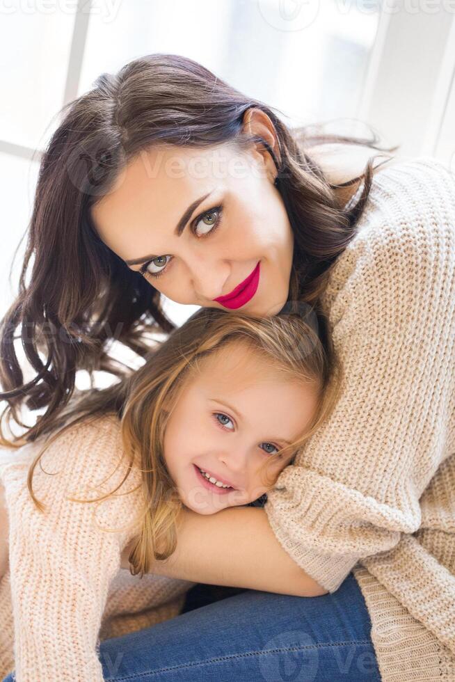 Young woman in the morning with small girl photo