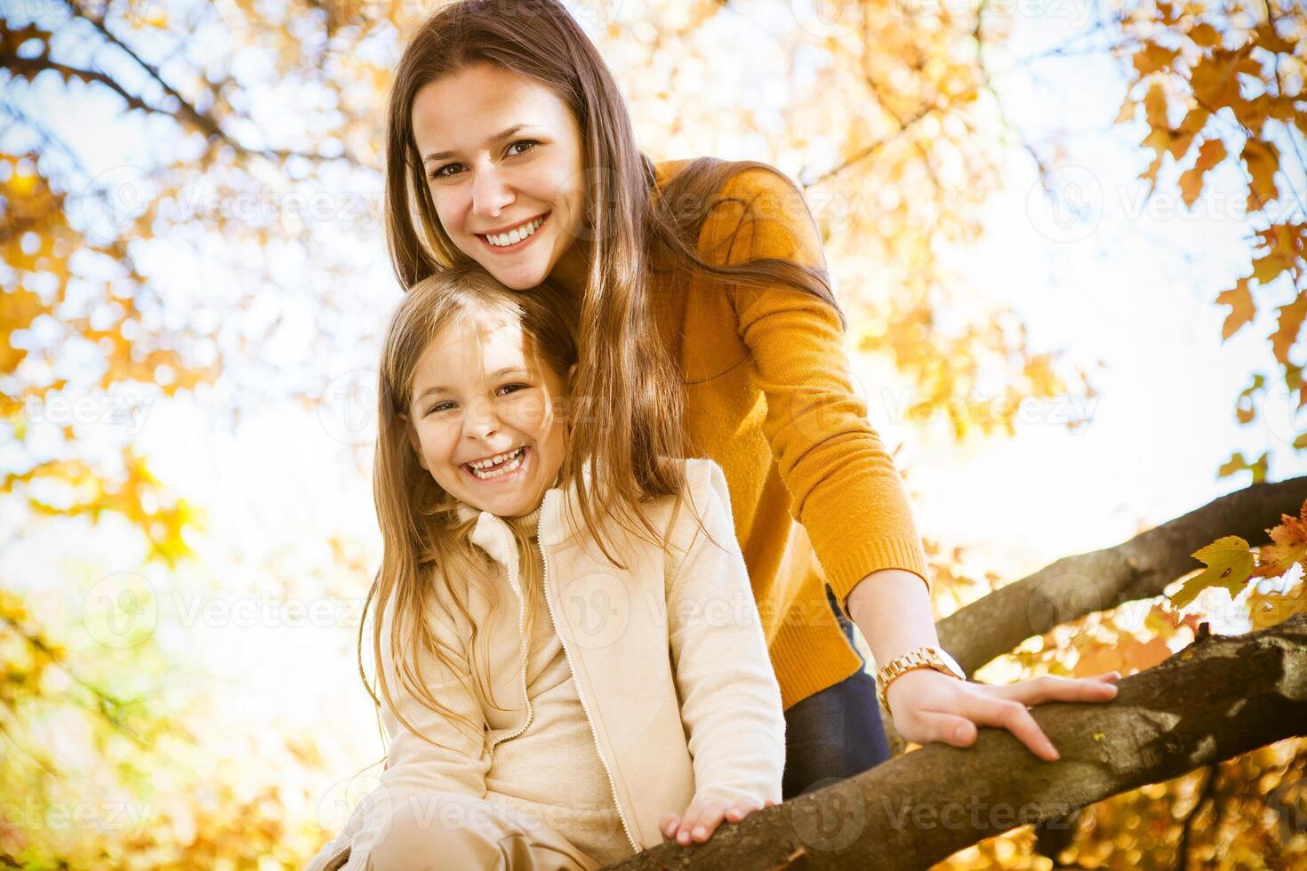 Two cheerful sisters playing in the park photo