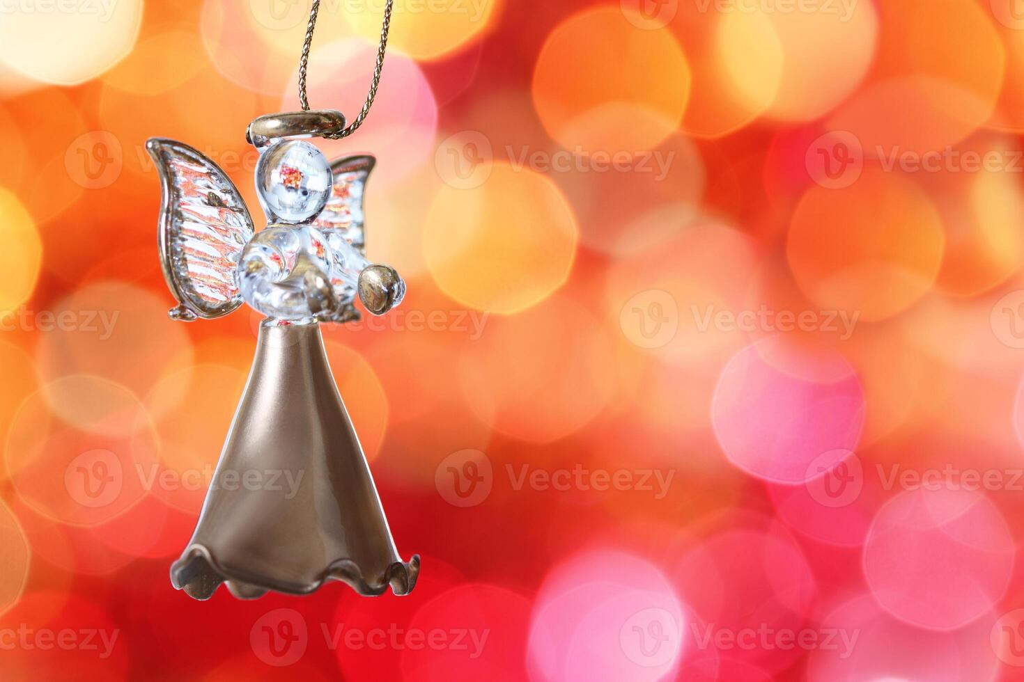 a christmas angel ornament hanging from a bell photo