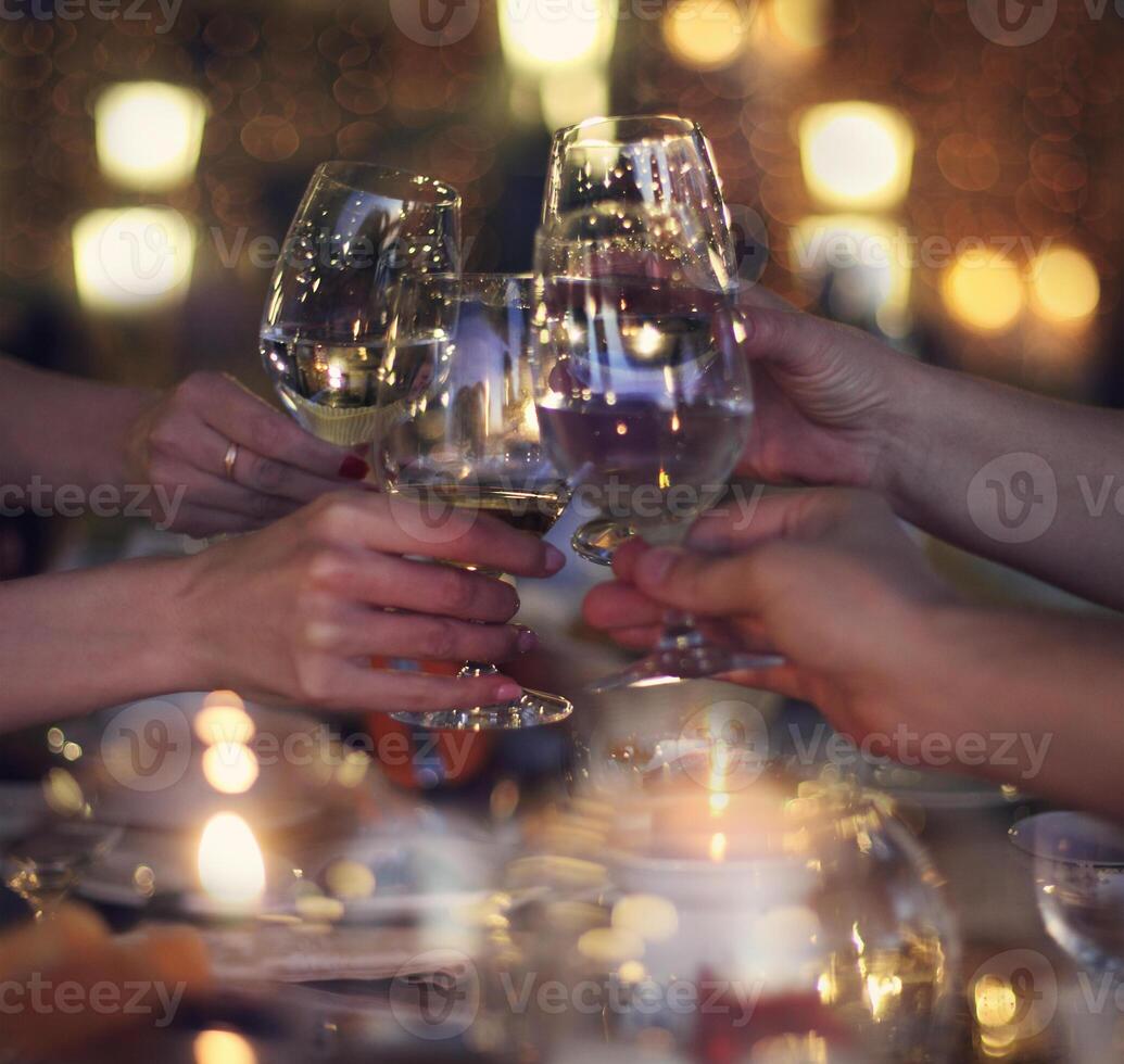 Celebration. People holding the glasses of white wine making a toast. photo