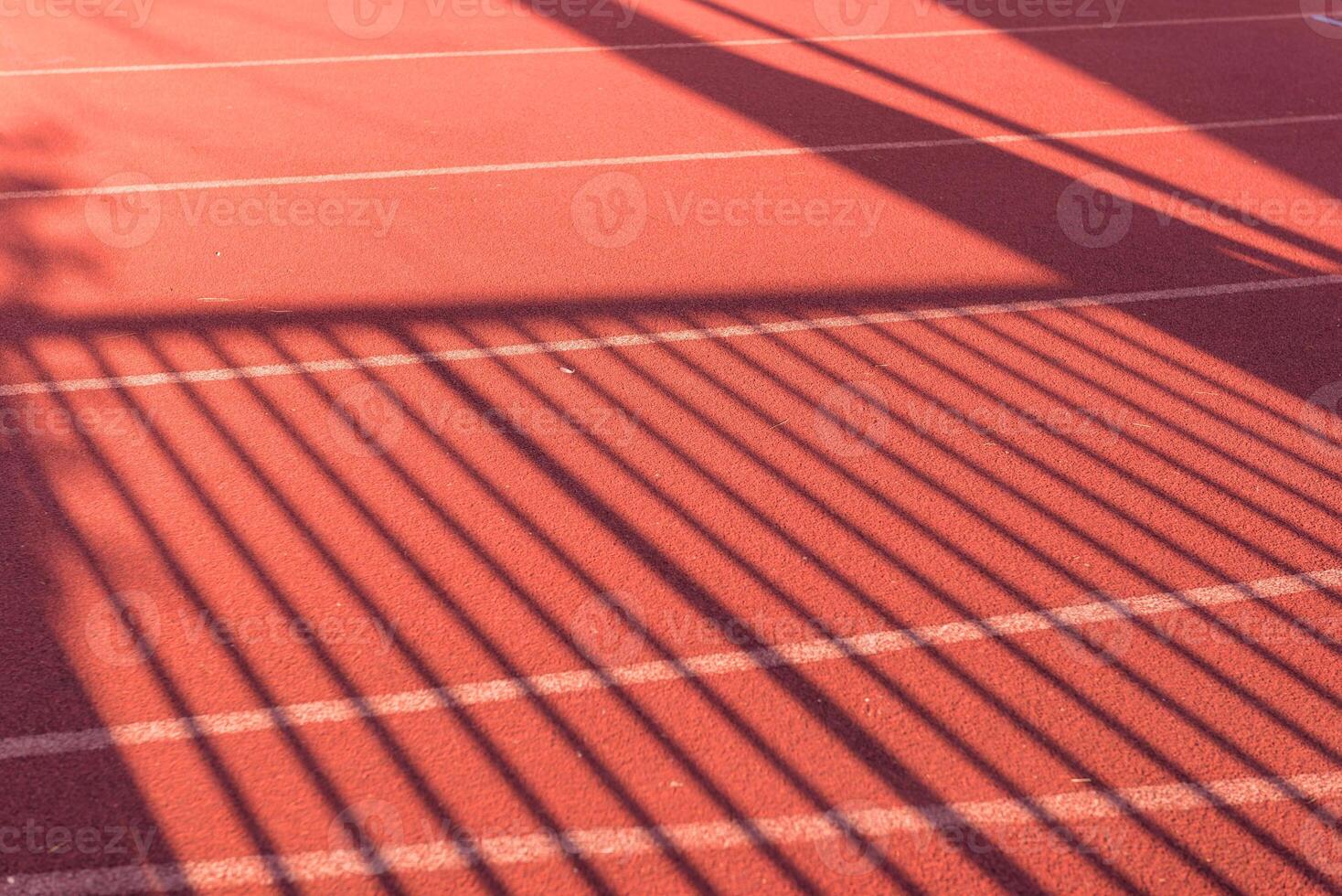 Shadow of palisade on running track photo
