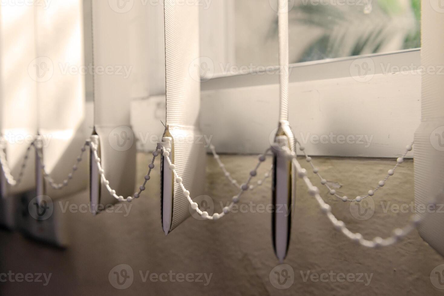 Modern vertical fabric blinds on the window in the office photo