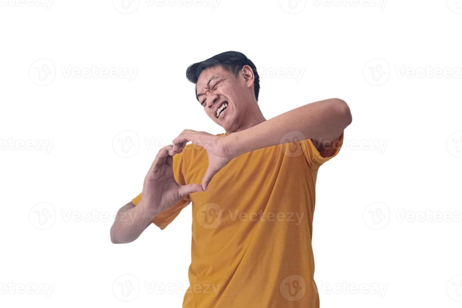 Handsome asian man with smiling in love doing heart symbol shape with hands. romantic concept.Indonesian man with love emoji. young Asian man feels happy and romantic shapes heart gesture expresses. photo