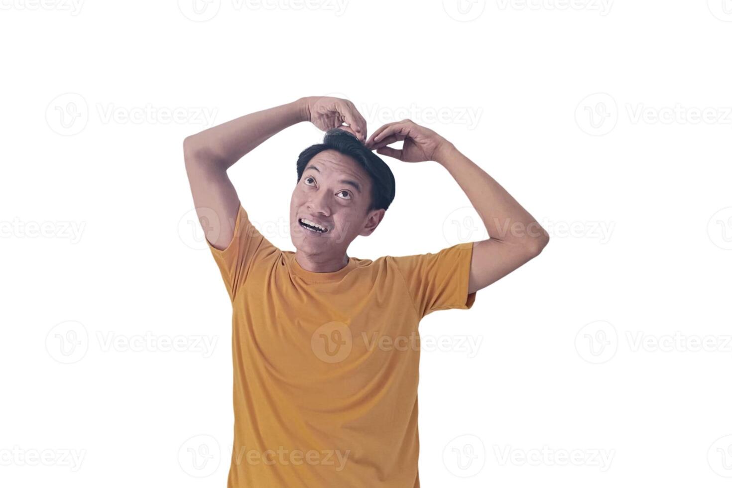 Handsome asian man with smiling in love doing heart symbol shape with hands. romantic concept.Indonesian man with love emoji. young Asian man feels happy and romantic shapes heart gesture expresses. photo