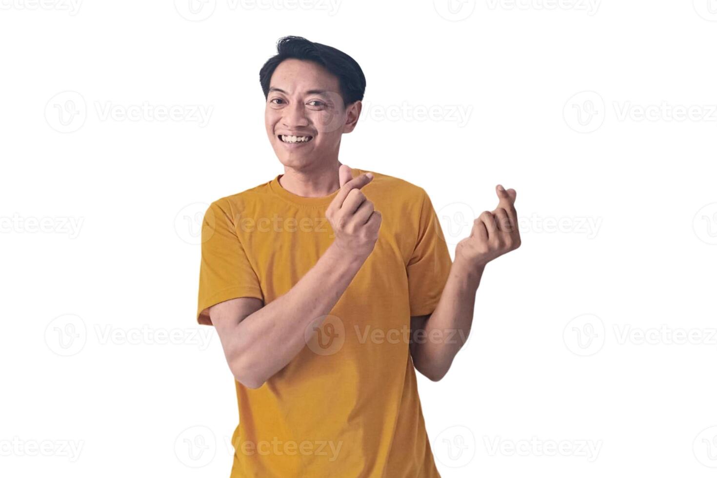 Handsome asian man with smiling in love doing heart symbol shape with hands. romantic concept.Indonesian man with love emoji. young Asian man feels happy and romantic shapes heart gesture expresses. photo