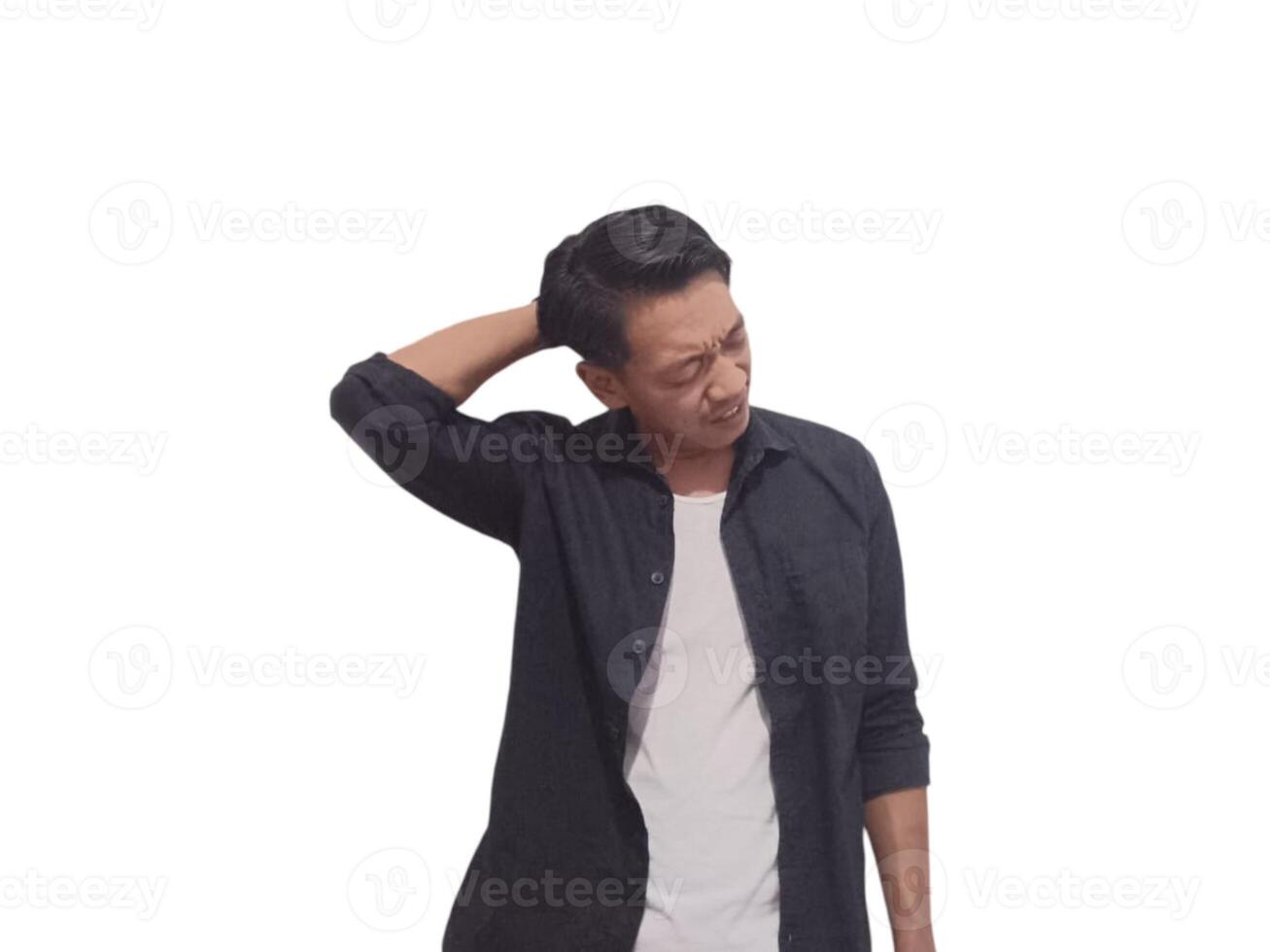 A man in a black shirt holds his neck with a pained expression, indicating discomfort or neck pain. The plain white background emphasizes his distress and highlights photo