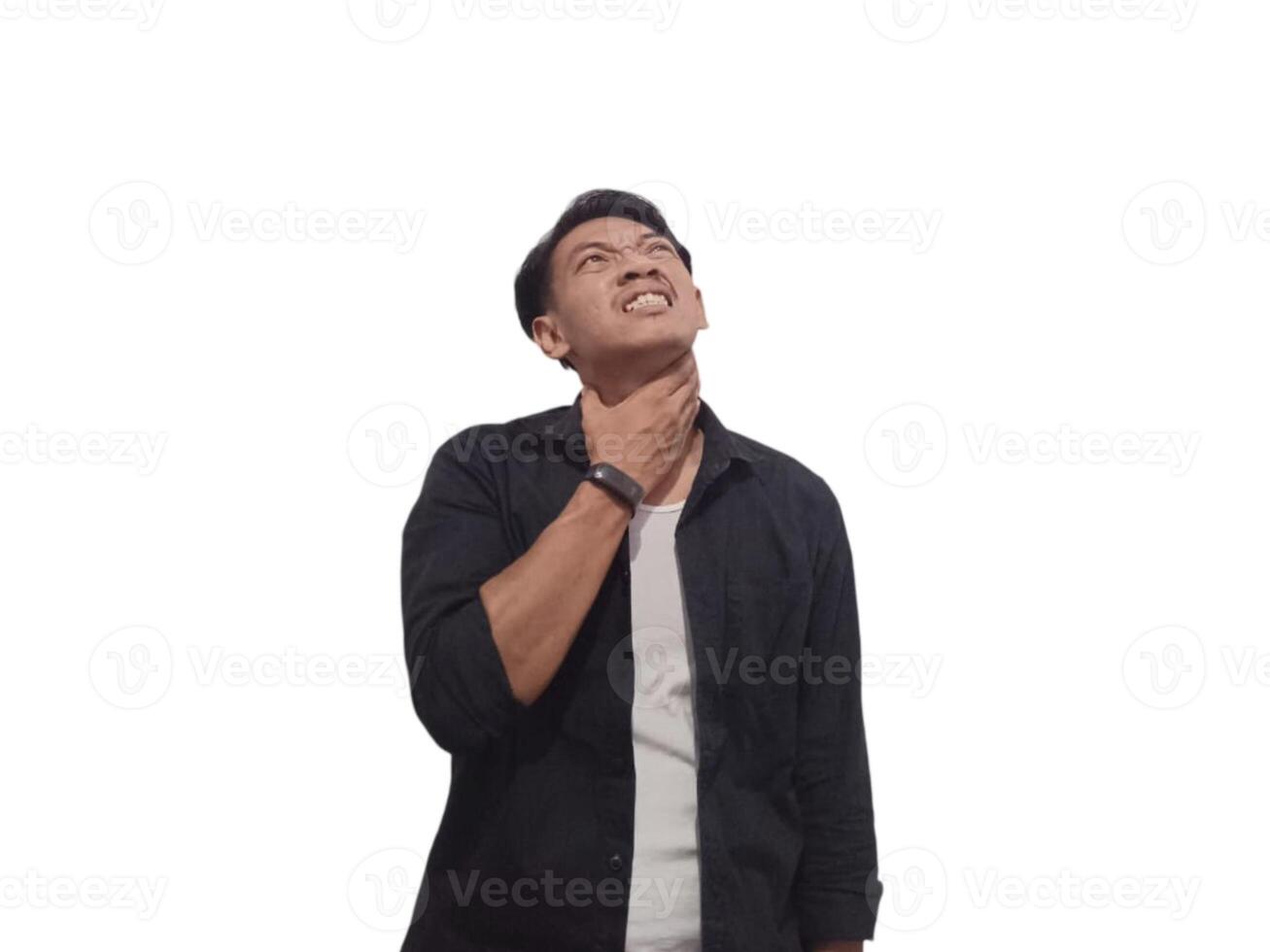 A young Asian man in a black shirt holds his throat, indicating discomfort or pain. The white background accentuates his expression photo