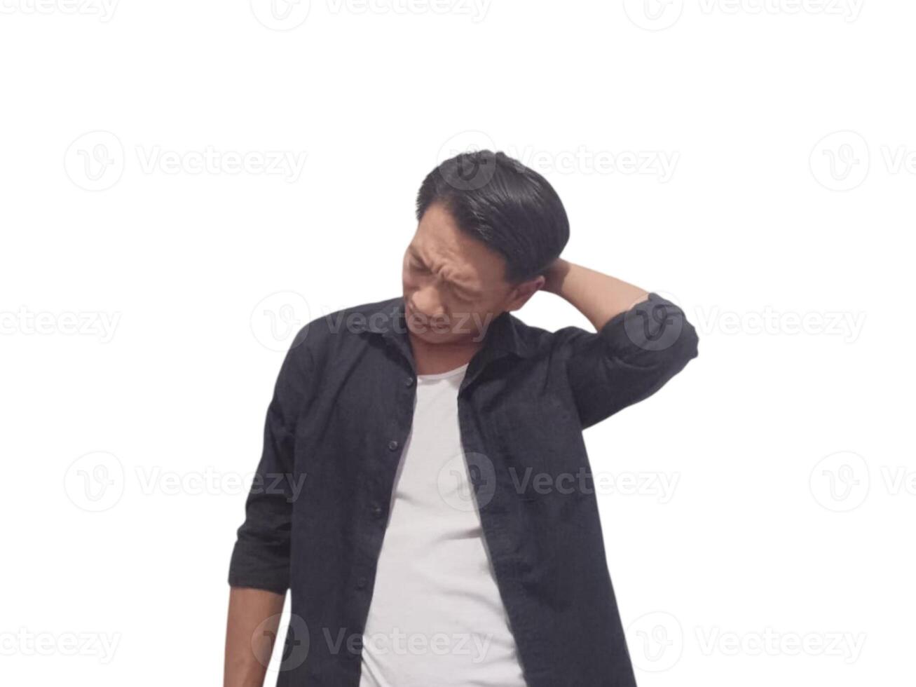 A man in a black shirt holds his neck with a pained expression, indicating discomfort or neck pain. The plain white background emphasizes his distress and highlights photo