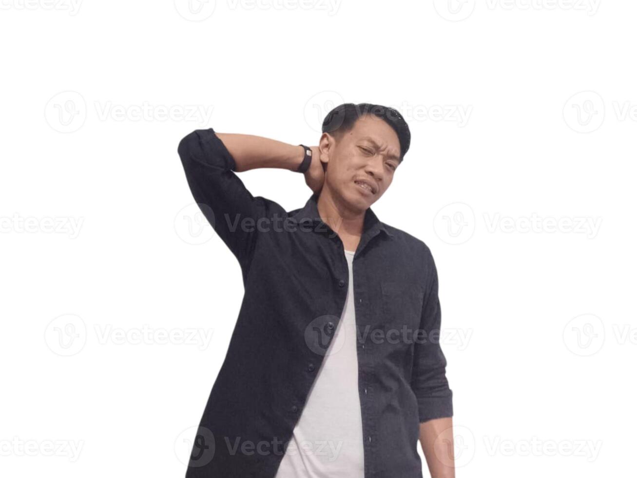 A man in a black shirt holds his neck with a pained expression, indicating discomfort or neck pain. The plain white background emphasizes his distress and highlights photo