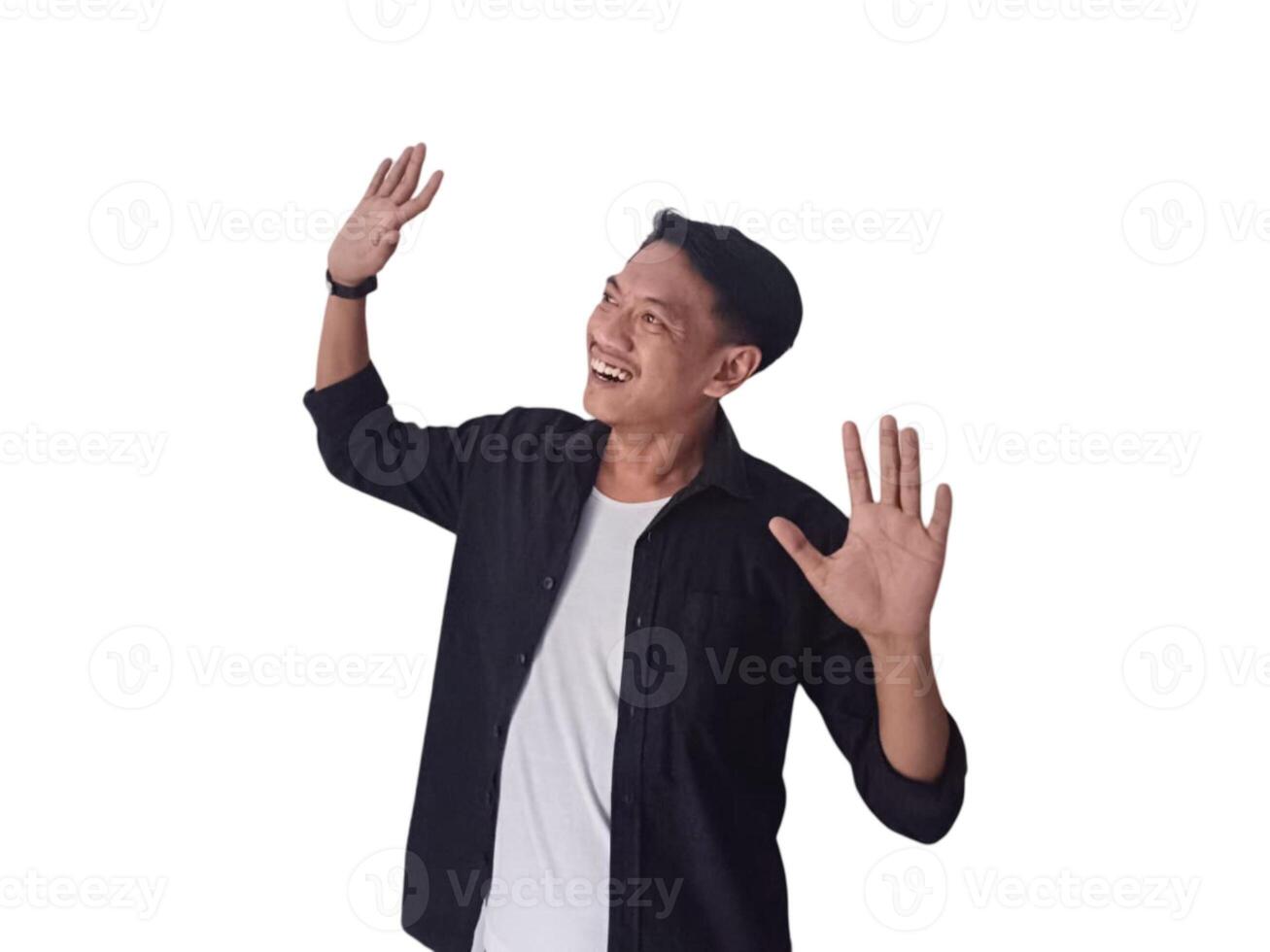Surprised young handsome Asian man looking upward with raised hands isolated on white background photo