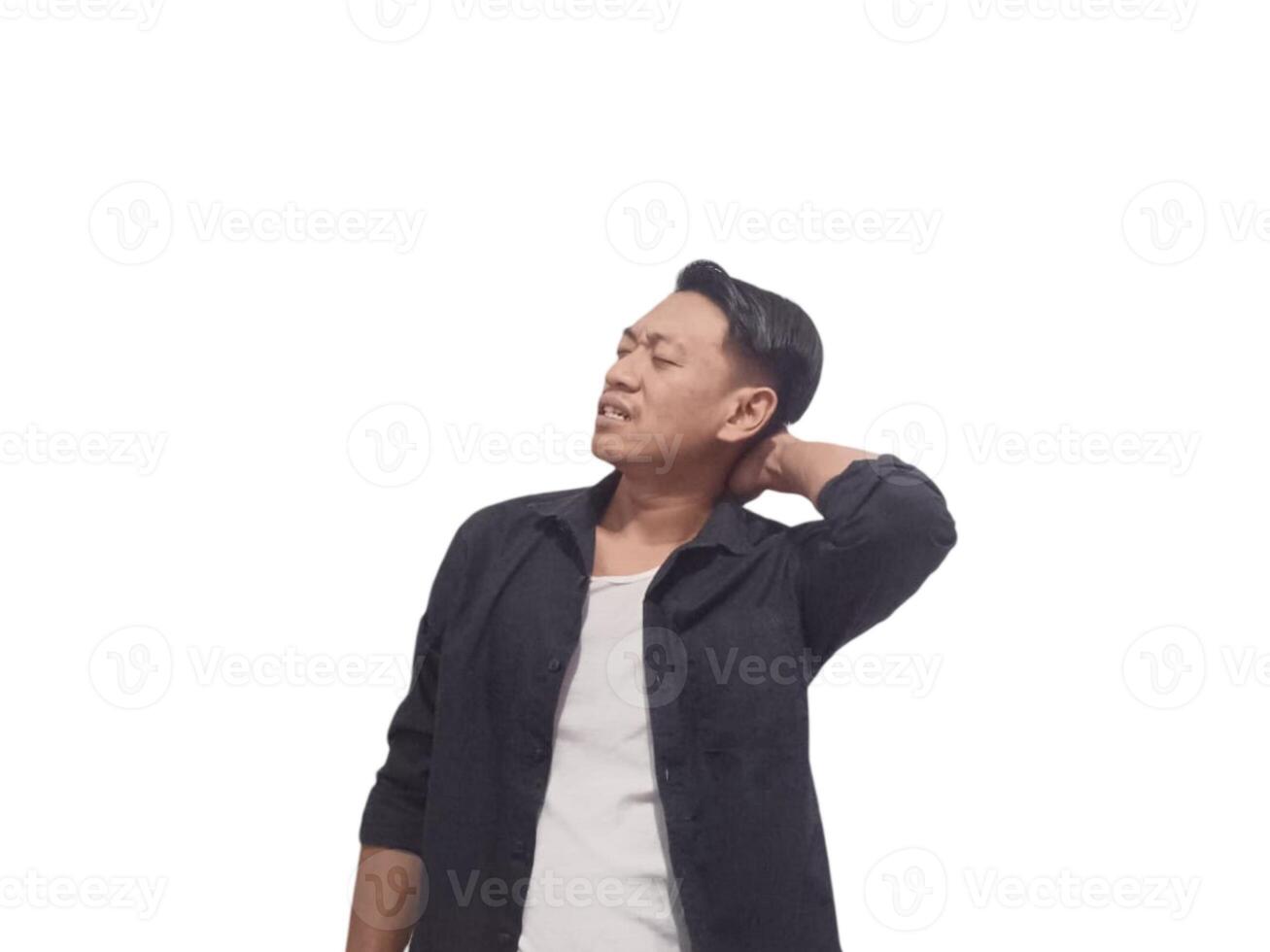 A man in a black shirt holds his neck with a pained expression, indicating discomfort or neck pain. The plain white background emphasizes his distress and highlights photo