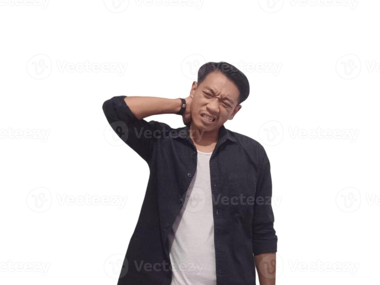 A man in a black shirt holds his neck with a pained expression, indicating discomfort or neck pain. The plain white background emphasizes his distress and highlights photo