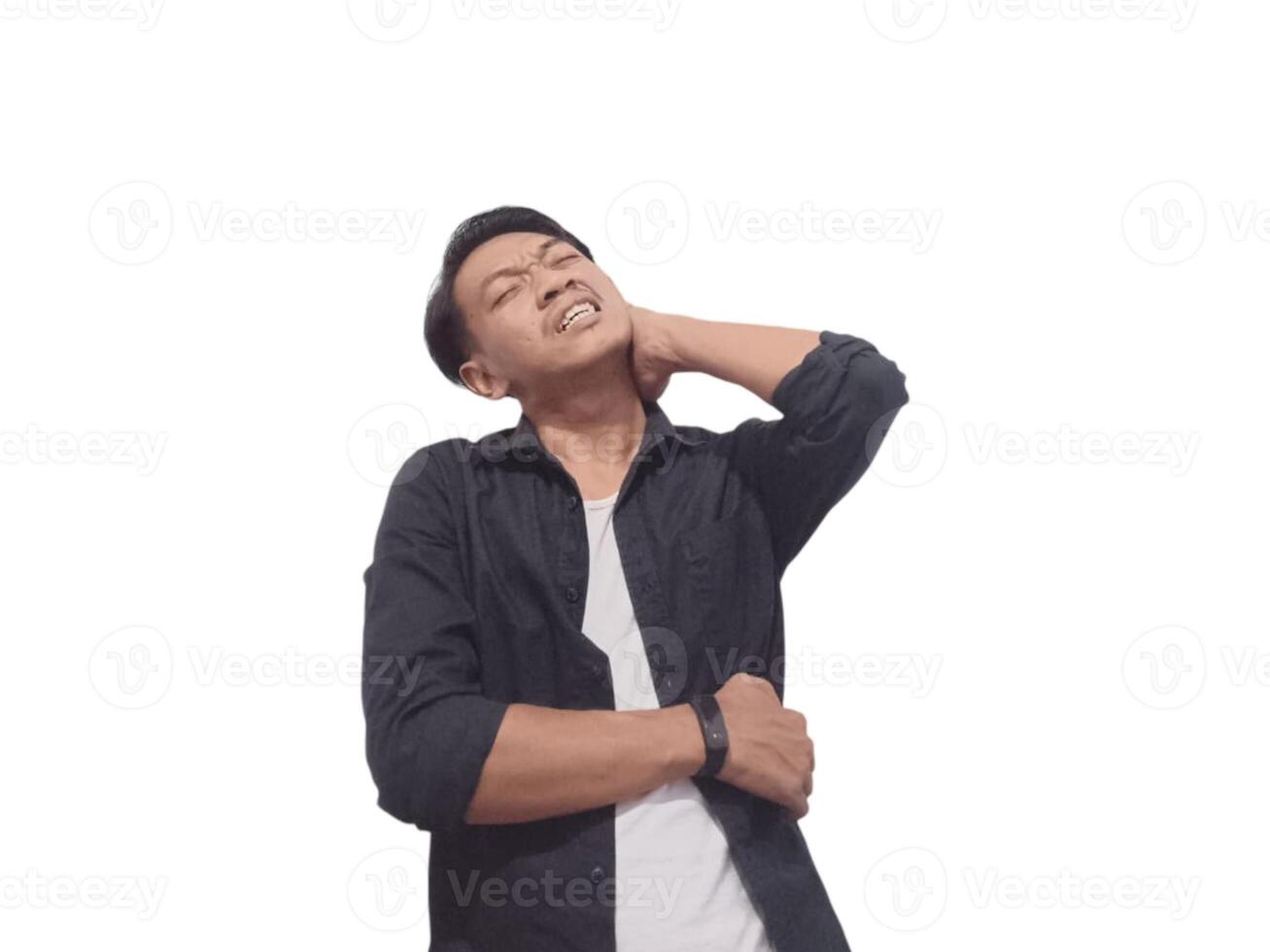 A man in a black shirt holds his neck with a pained expression, indicating discomfort or neck pain. The plain white background emphasizes his distress and highlights photo