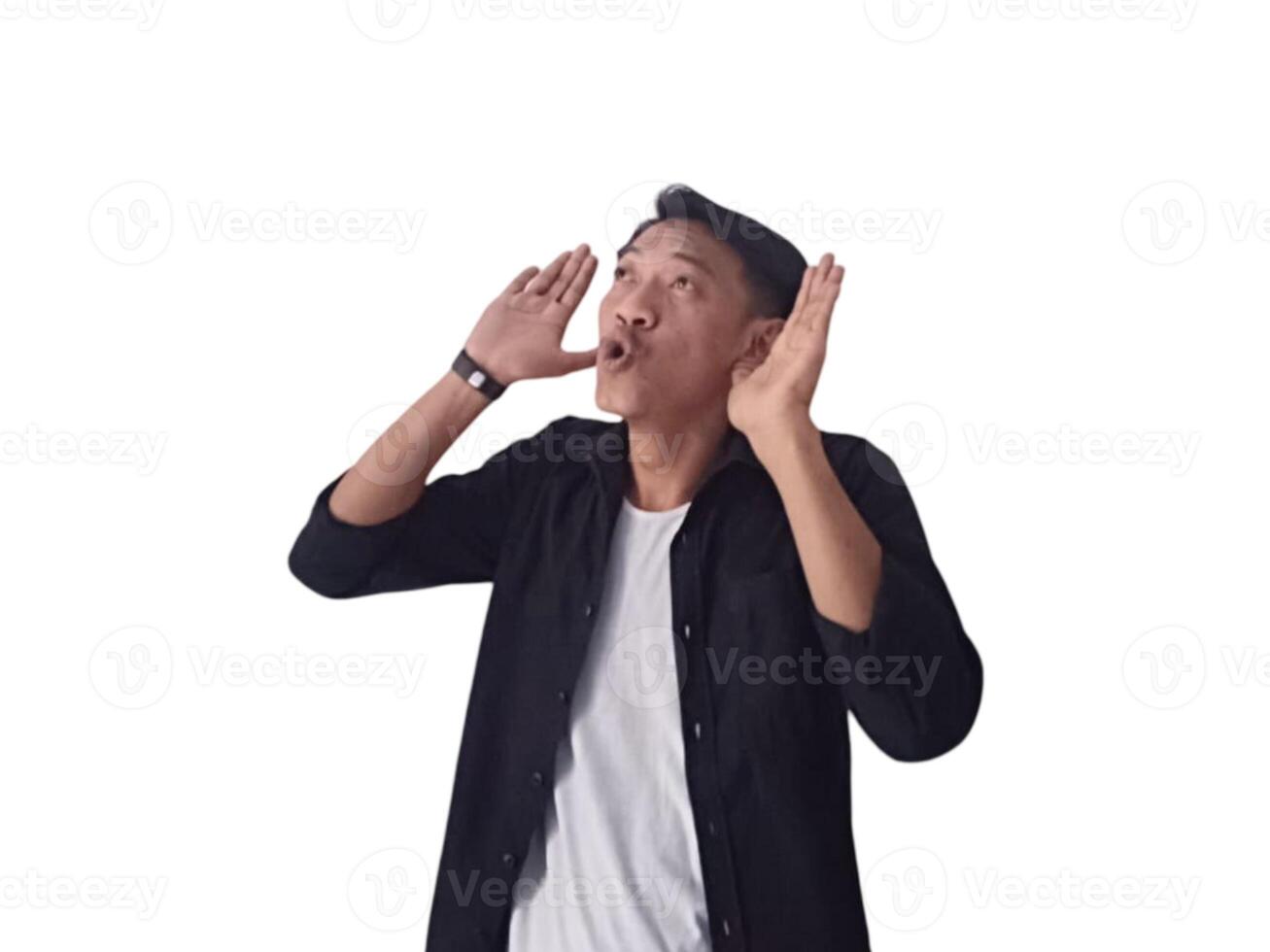 Surprised young handsome Asian man looking upward with raised hands isolated on white background photo