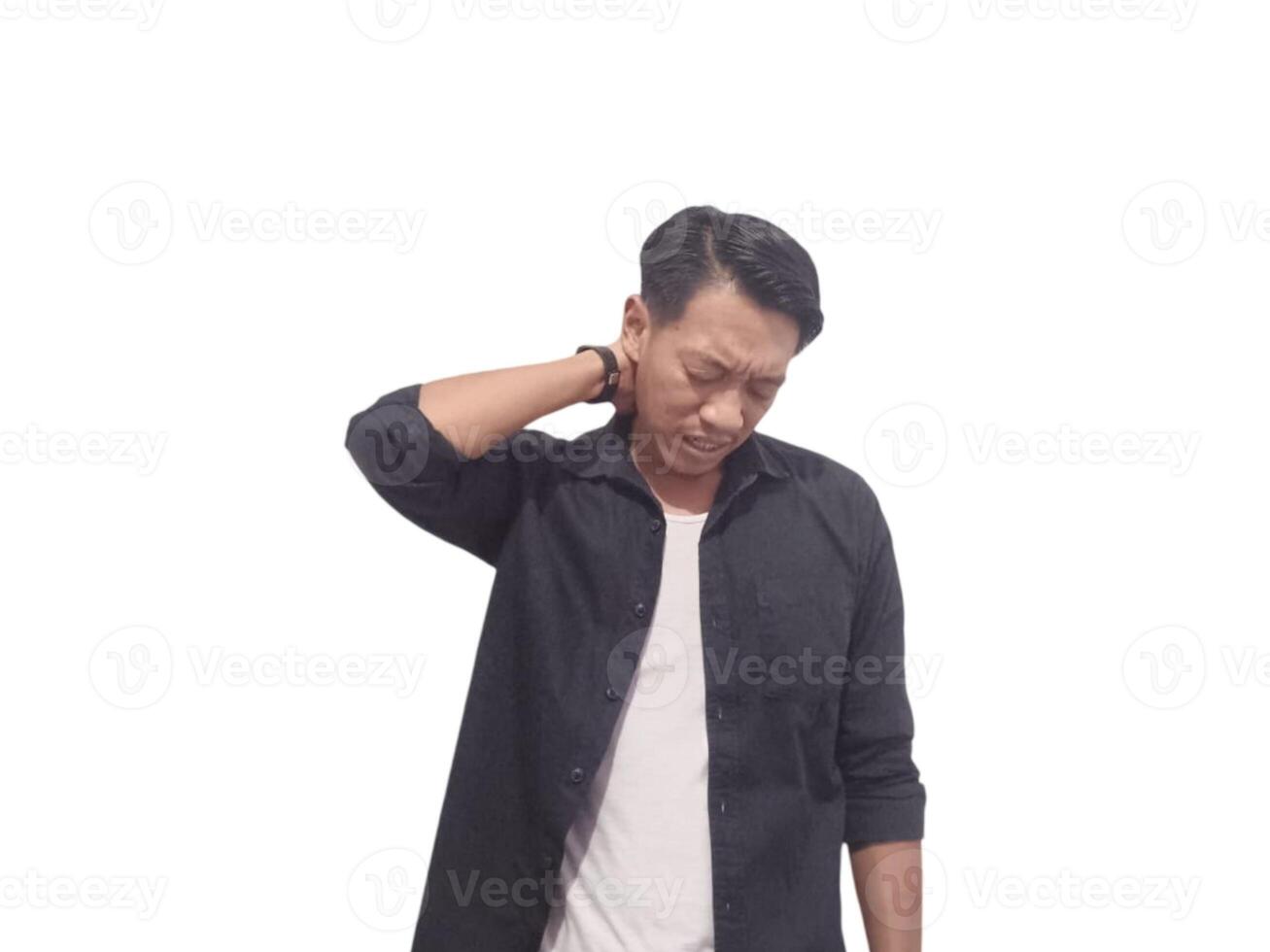 A man in a black shirt holds his neck with a pained expression, indicating discomfort or neck pain. The plain white background emphasizes his distress and highlights photo