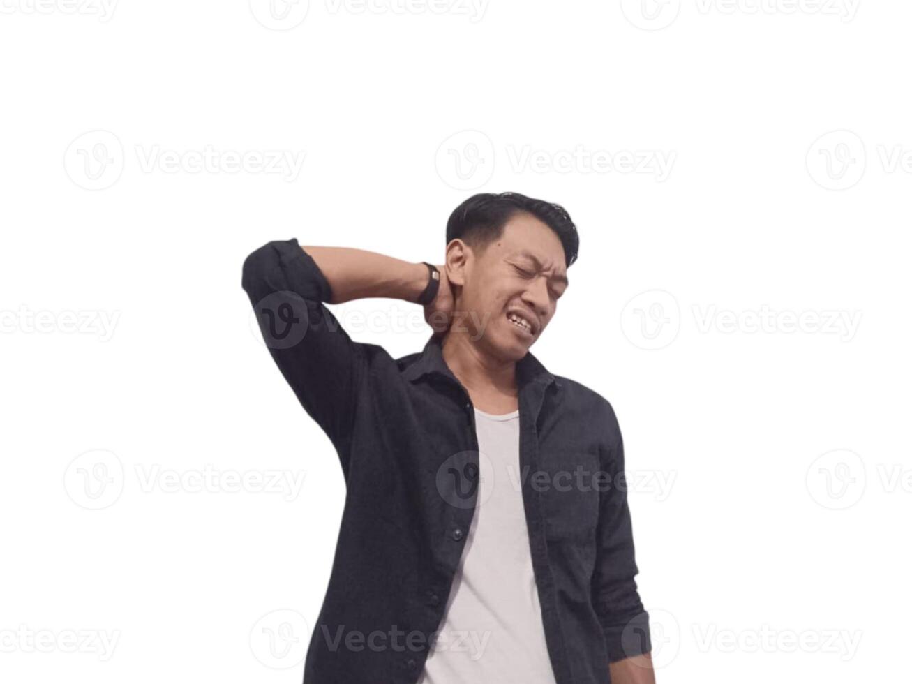 A man in a black shirt holds his neck with a pained expression, indicating discomfort or neck pain. The plain white background emphasizes his distress and highlights photo