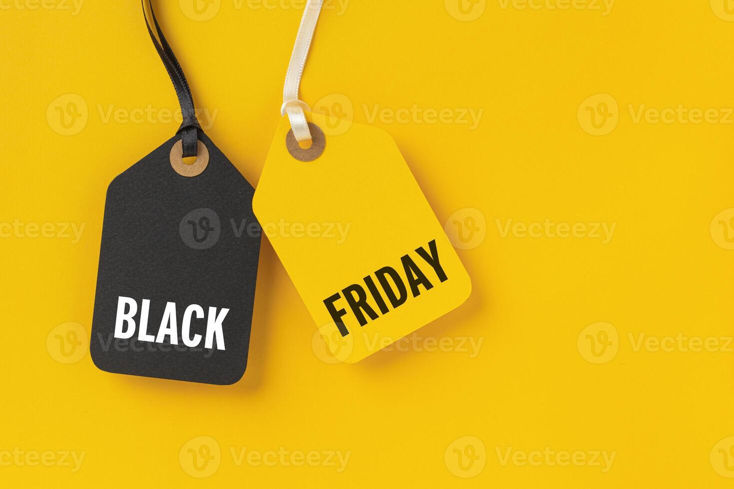 Sale tags with Black Friday written on yellow background photo