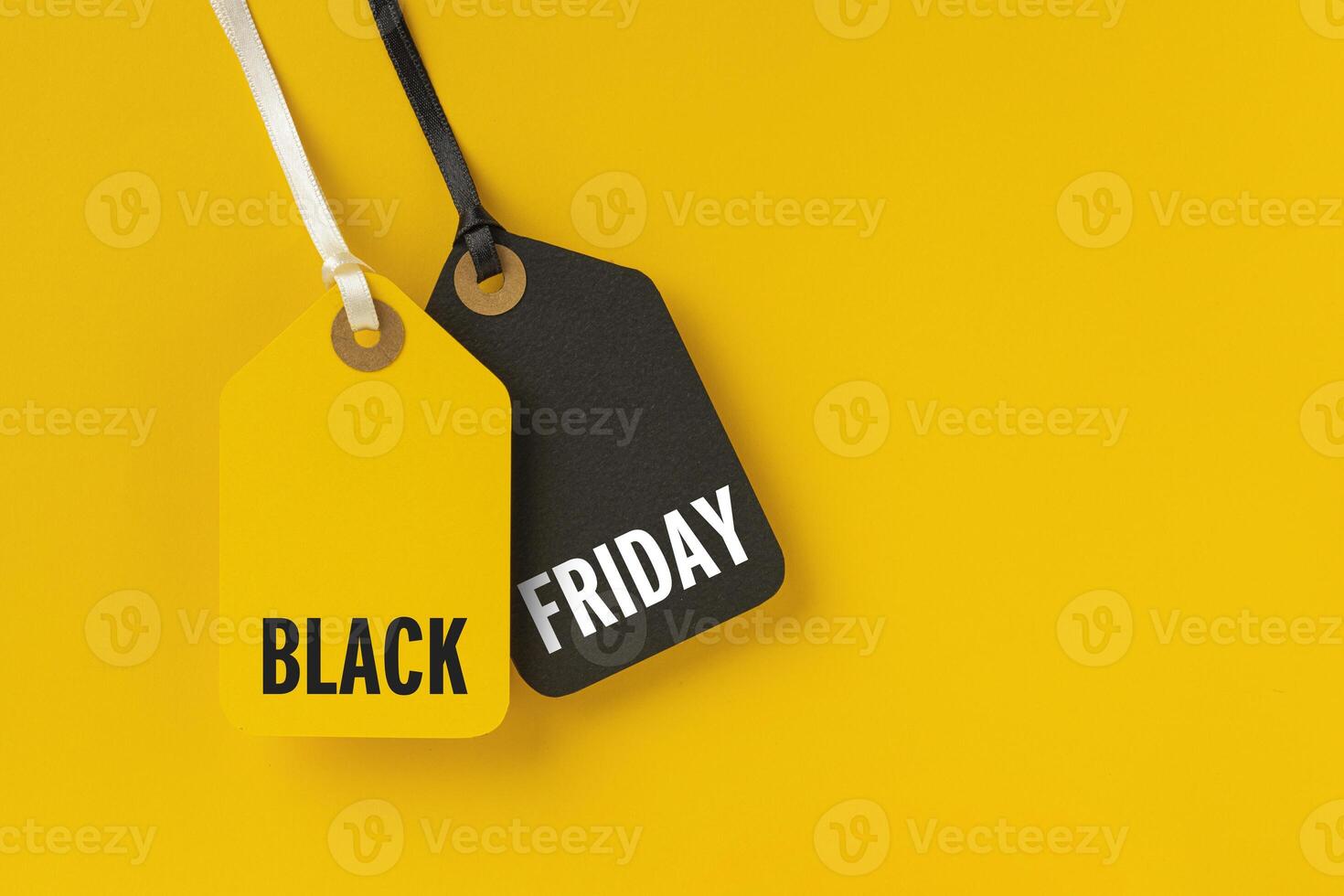 Sale tags with Black Friday written on yellow background photo