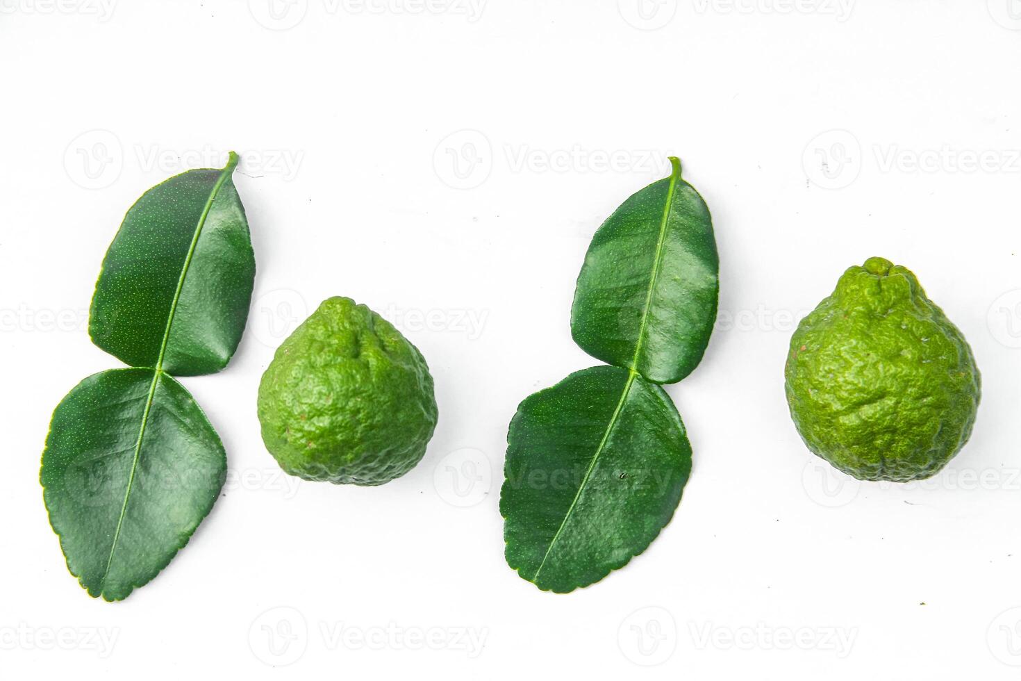 Citrus hystrix or kaffir lime or bergamot sliced fruit and its leaves isolated on white background photo