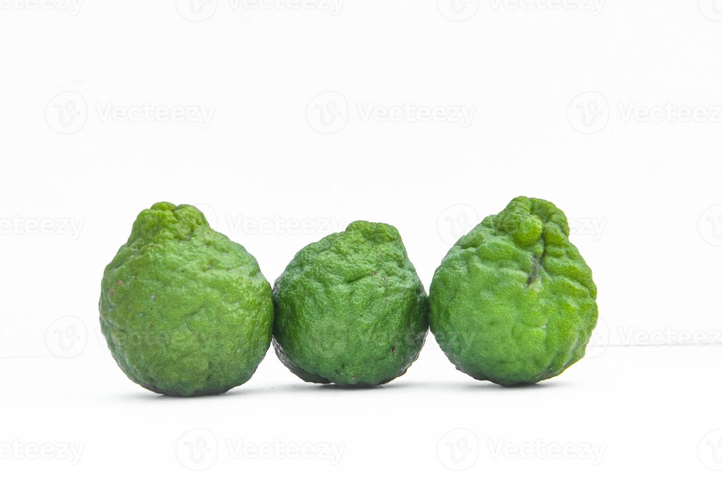 Citrus hystrix or kaffir lime or bergamot sliced fruit and its leaves isolated on white background photo