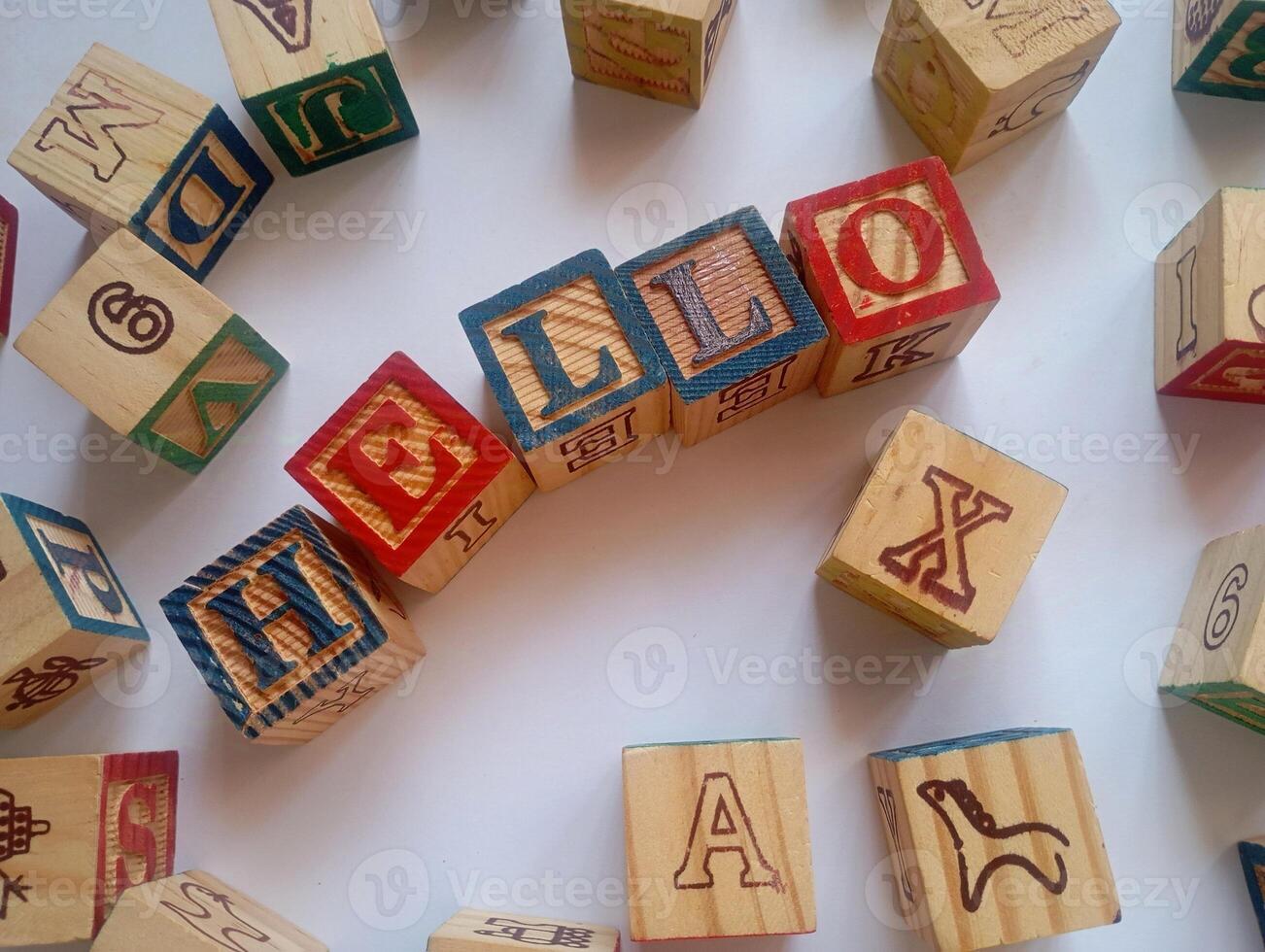 A photo of a wooden block with the words hello written on it, styled in isolation with space for text.