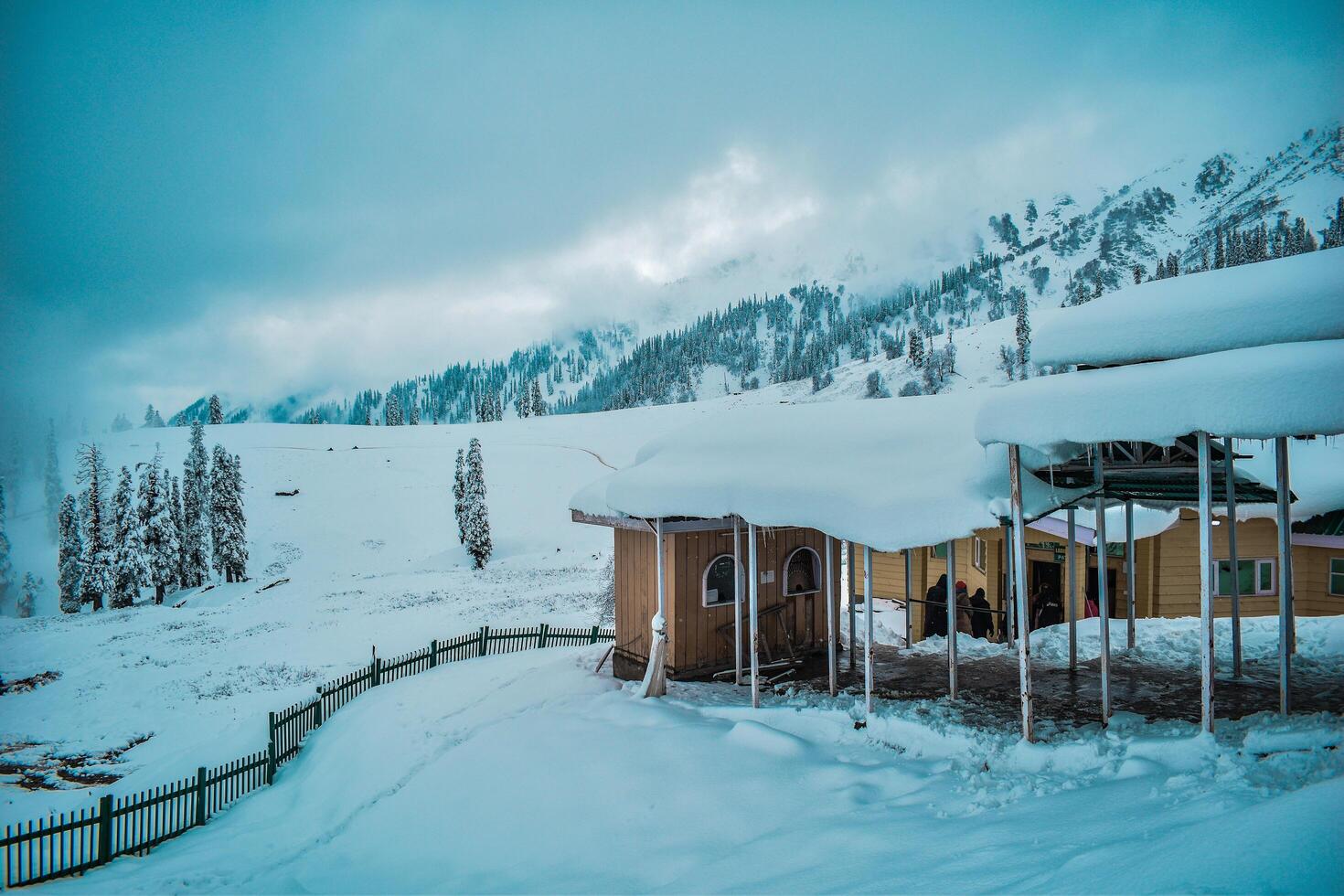A cozy cabin nestled in the snowy mountains, a peaceful haven away from it all. Tranquil solitude amidst nature's embrace. photo