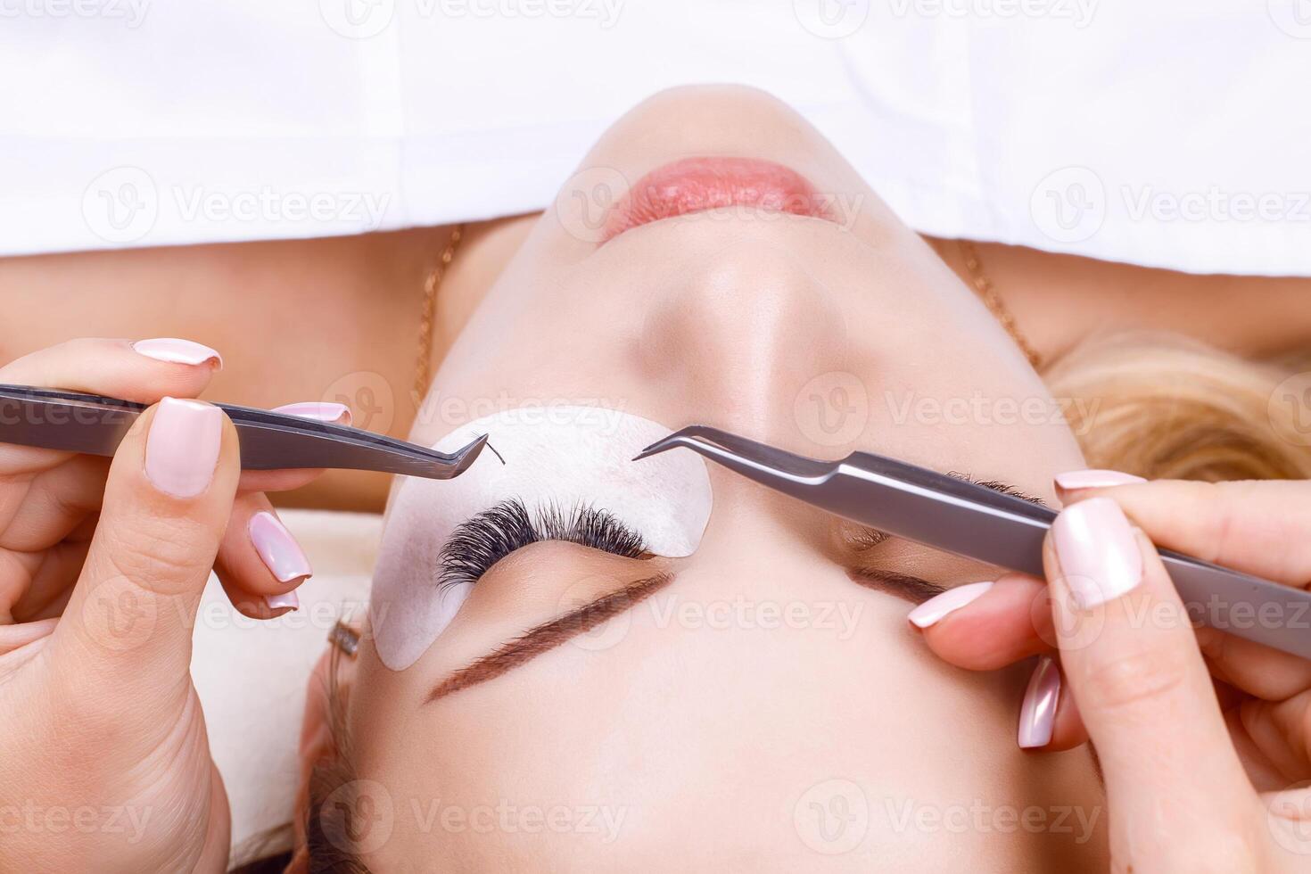 Eyelash Extension Procedure. Woman Eye with Long Eyelashes. Lashes, close up, macro, selective focus. photo