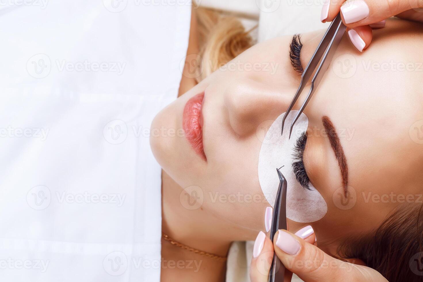 Eyelash Extension Procedure. Woman Eye with Long Eyelashes. Lashes, close up, macro, selective focus. photo