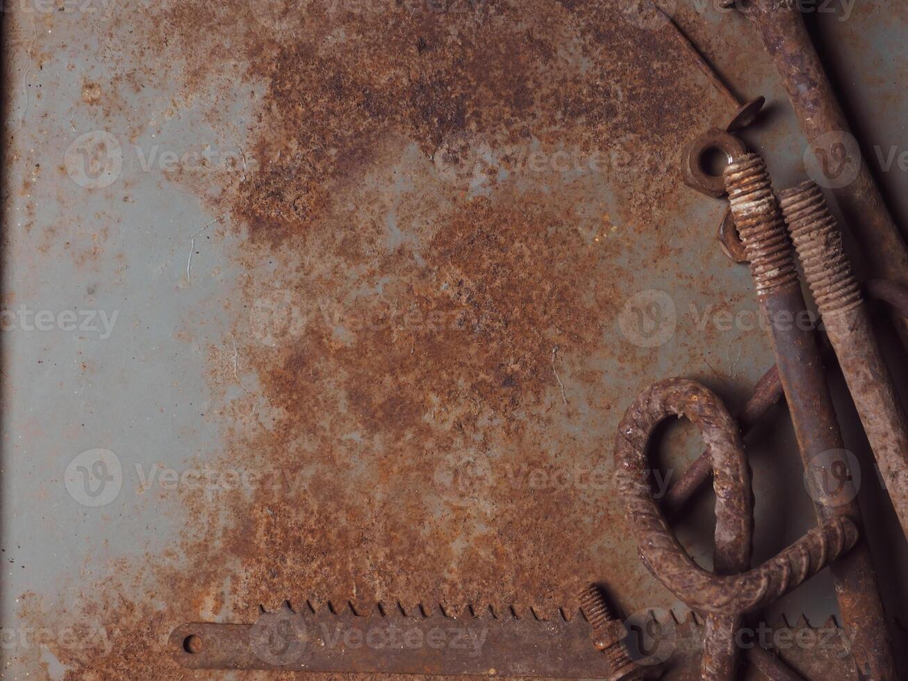 Rusted steel surface with old nails and equipment for a vintage background. photo