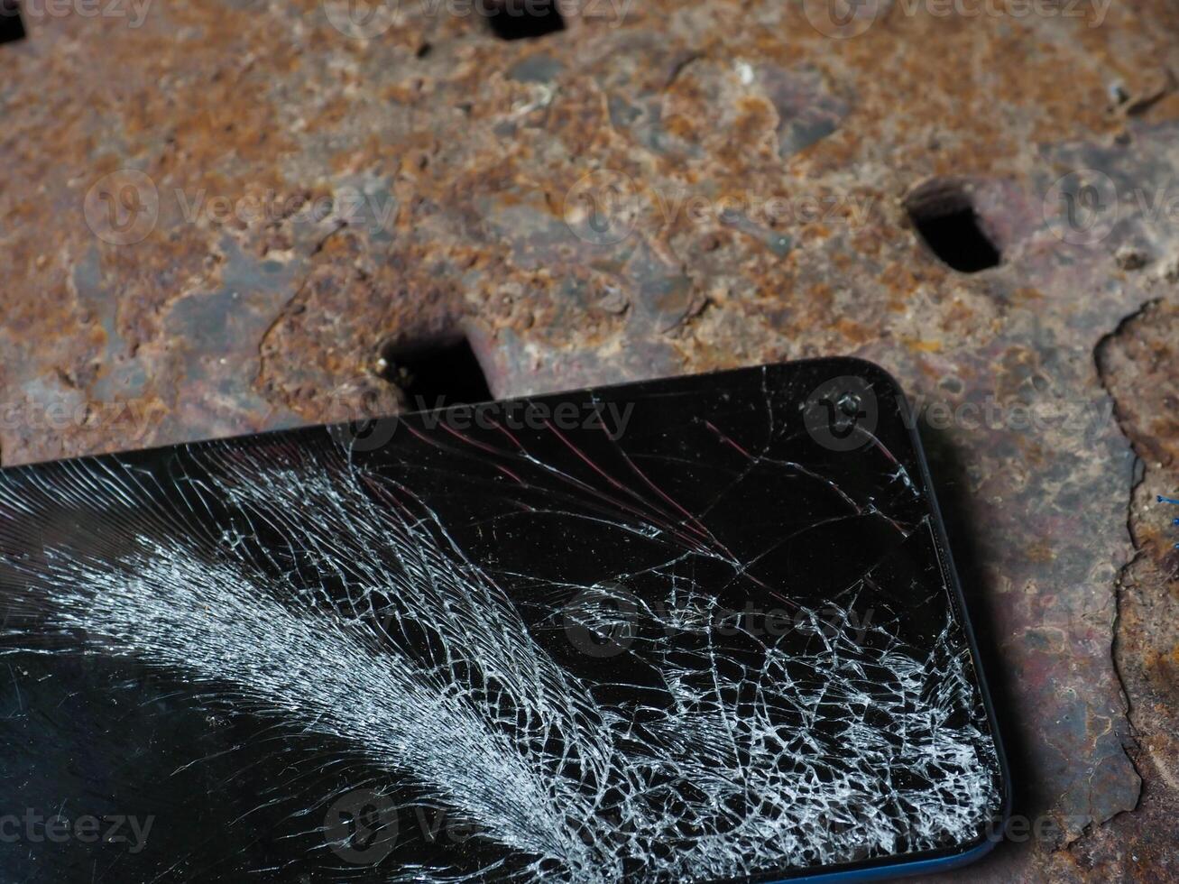 The mobile phone fell on the floor and the screen cracked. photo
