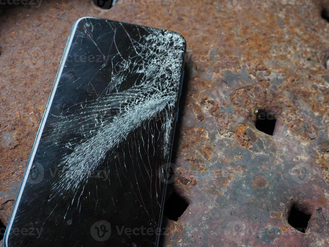 The mobile phone fell on the floor and the screen cracked. photo