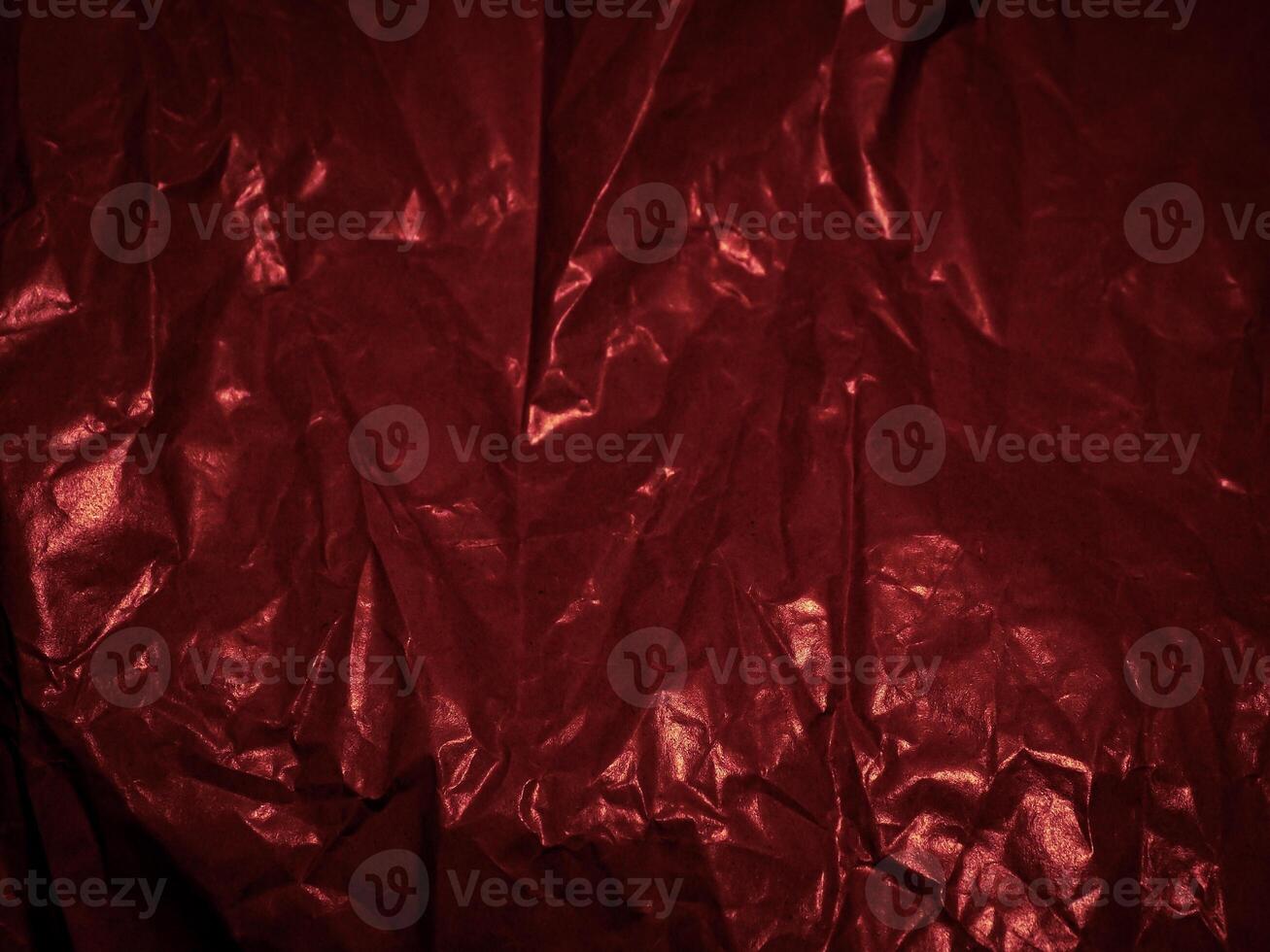 Wrinkled paper texture in dark red tones for a mysterious background. photo