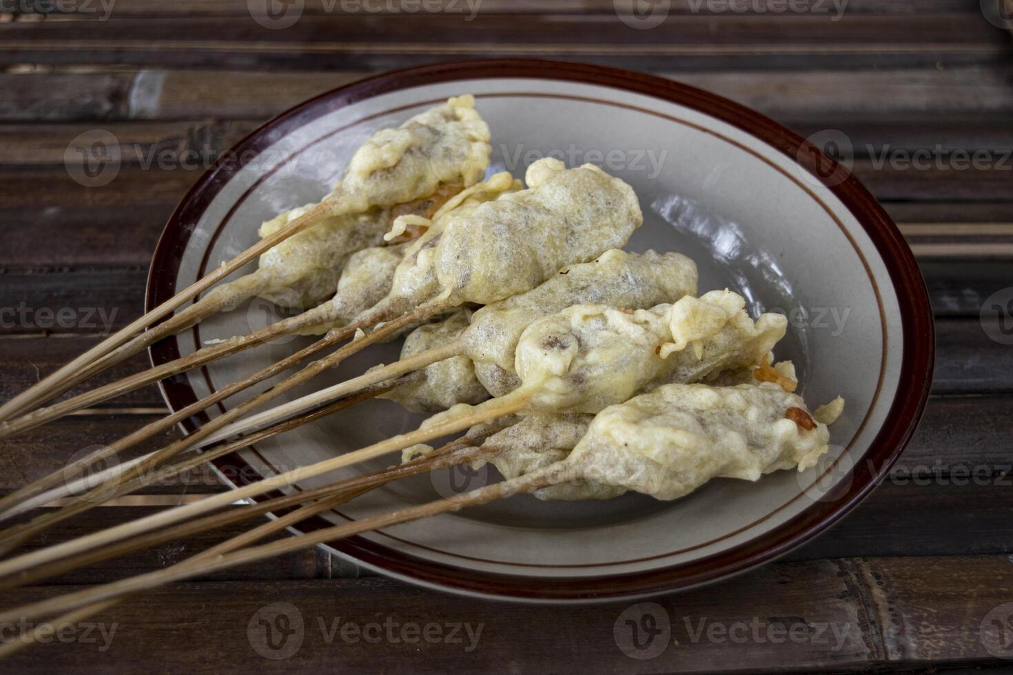 Sempolan or sempol is a type of fried food made from tapioca flour which is oval in shape and skewered, with a chewy texture, eaten with spicy red sauce and soy sauce or can be added with peanut sauce photo