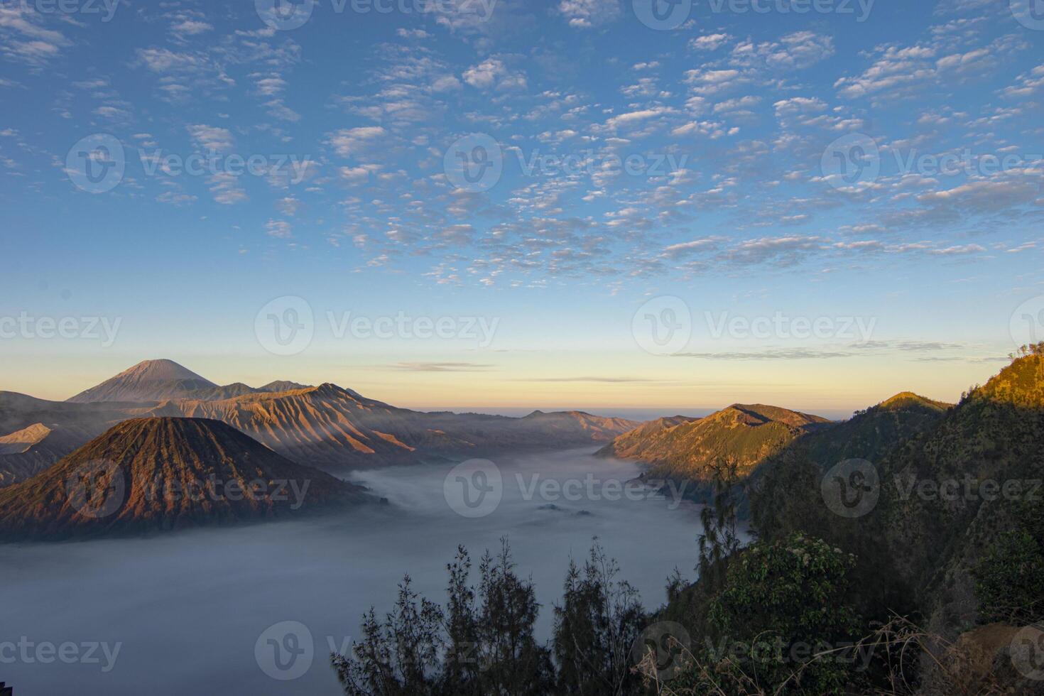 Beautiful wide angle view of Bromo Tengger Semeru National Park, an ecosystem conservation area consisting of mountains and calderas that has a desert area located in East Java, Indonesia. photo