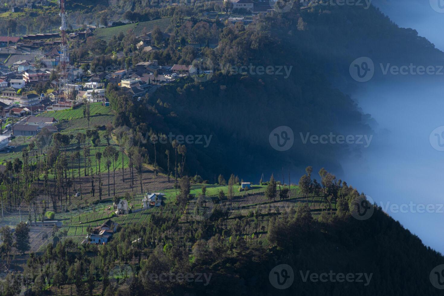 Aerial view of a village called Cemoro Lawang and a foggy valley in Probolingo, East Java, Indonesia. photo