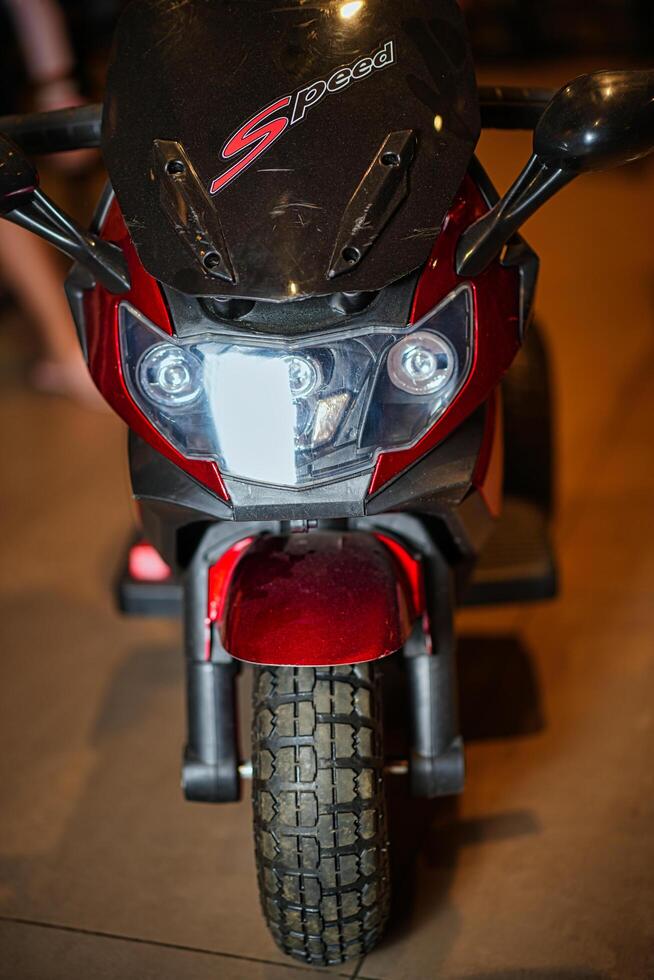 A close up of a motorcycle with a person standing behind it photo