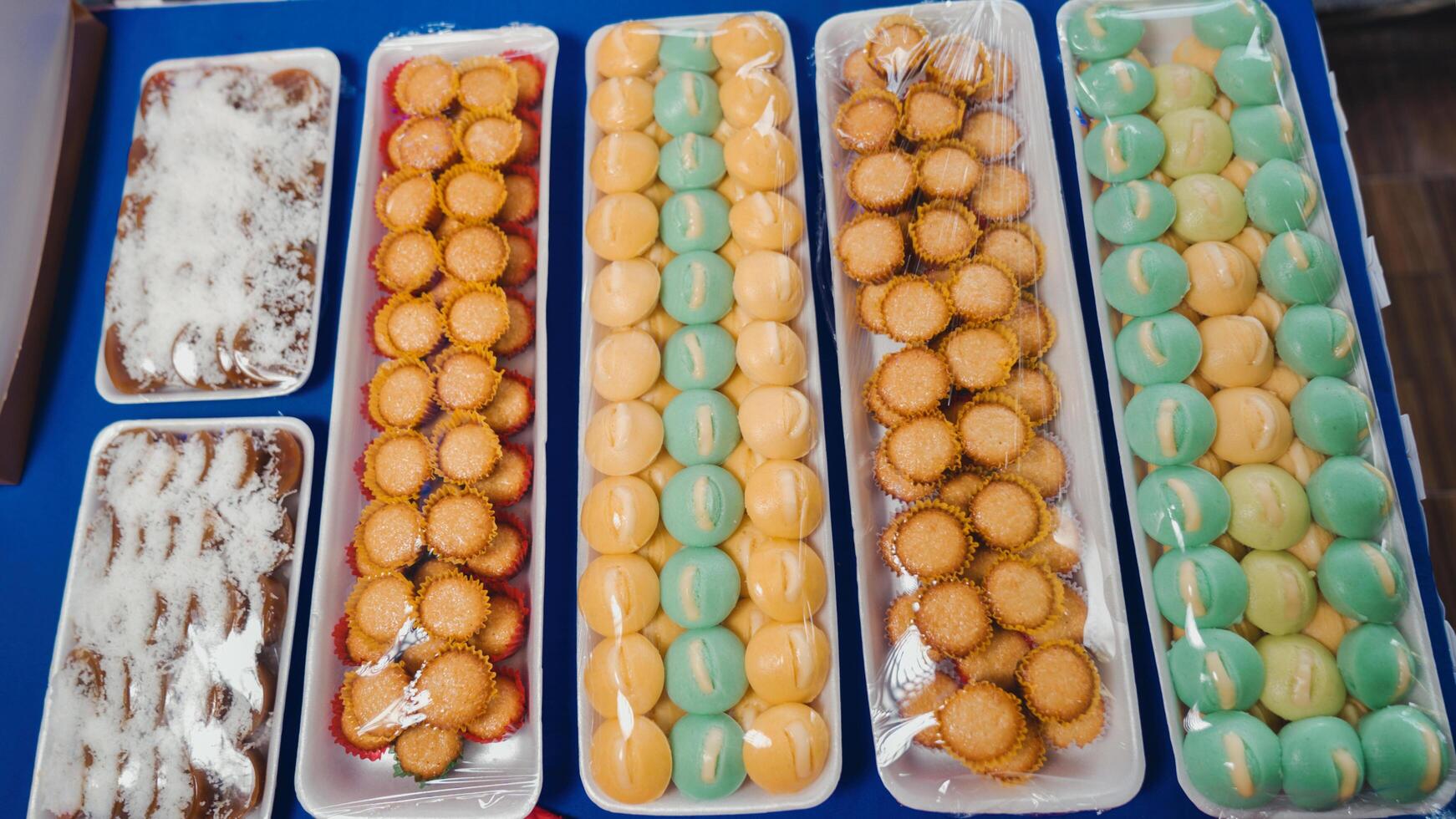 A tray of different types of pastries on a blue table photo