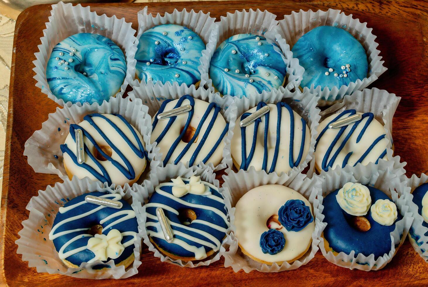 A tray of donuts with blue and white icing photo