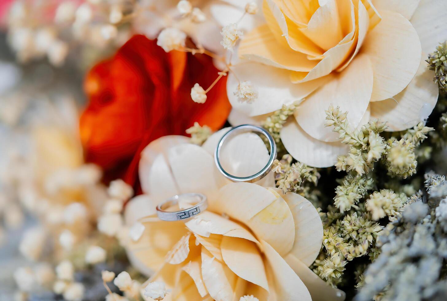 Wedding rings on a bouquet of flowers photo