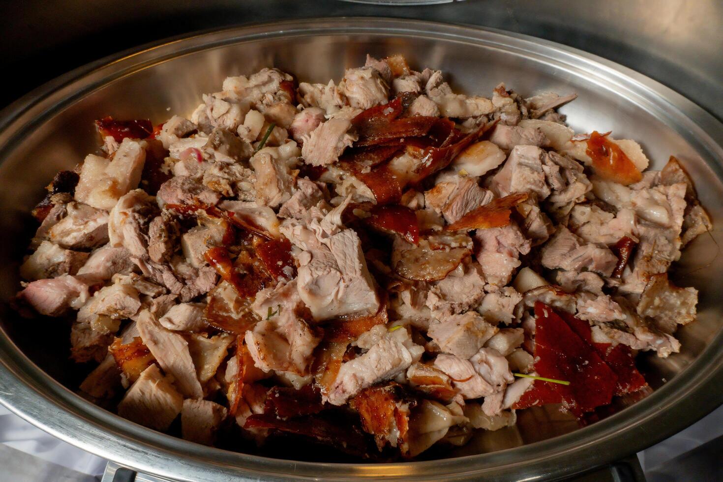 A bowl of meat and vegetables in a metal pan photo